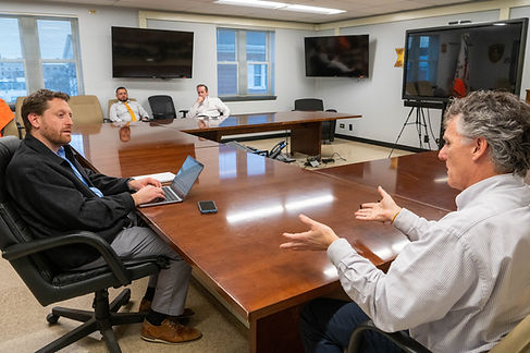 Men speaking at conference room table
