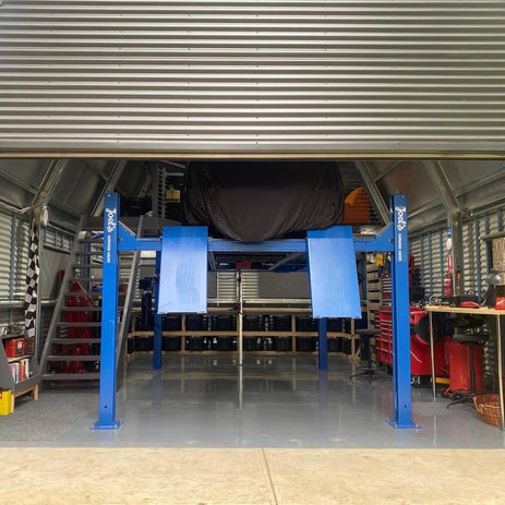 Image of a home car shed with a custom fitout of storage shelves in the Adelaide Hills