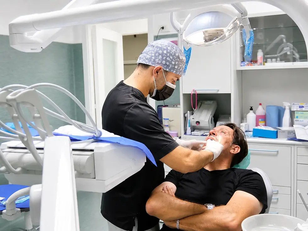 Dentista a Catania mentre esegue un intervento su un paziente
