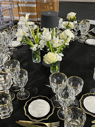 Allestimento tavolo elegante con fiori bianchi per eventi.