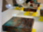 photo showing resin being poured out on top of a textured piece of art