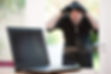 Burglar looking at laptop through window