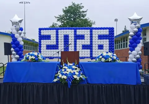 Blue and white balloon wall displaying 2026 for graduation.