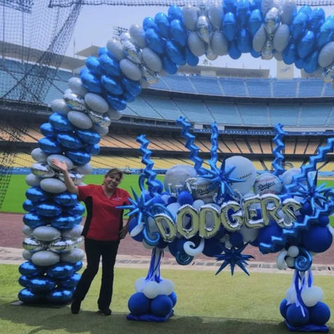 Dodgers Stadium Balloon Arch: Large blue and white professional balloon arch with a custom "Dodgers" balloon sculpture on a baseball field.