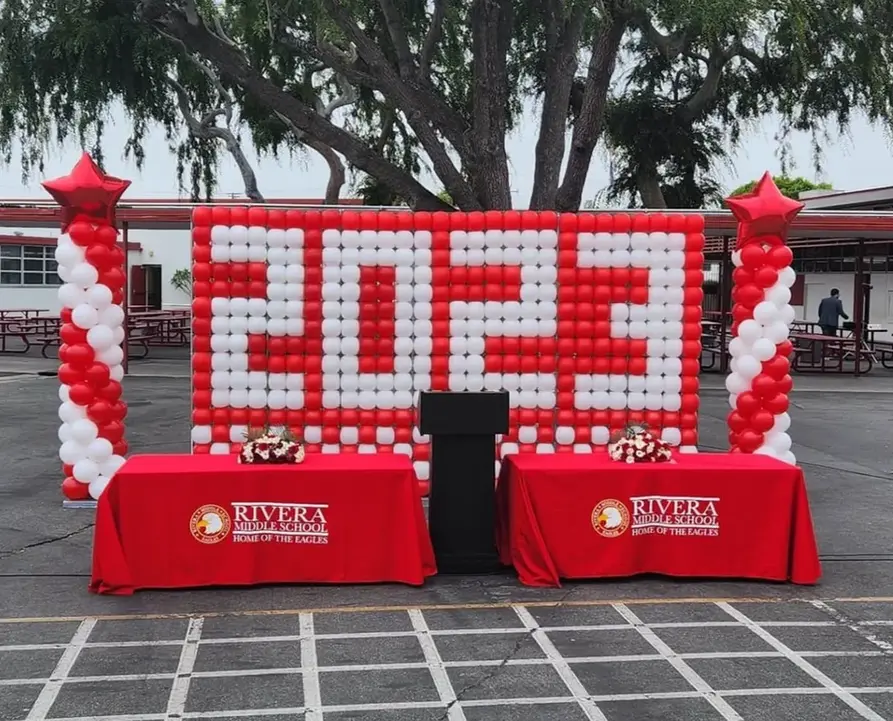 Red and white balloon wall displaying 2023 for Rivera Middle School.