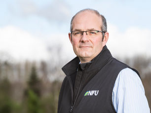 Tom Bradshaw, NFU President in a gilet posing for a photo