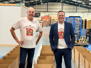 Paul and Luke in festive food parcel t-shirts standing with the food donated