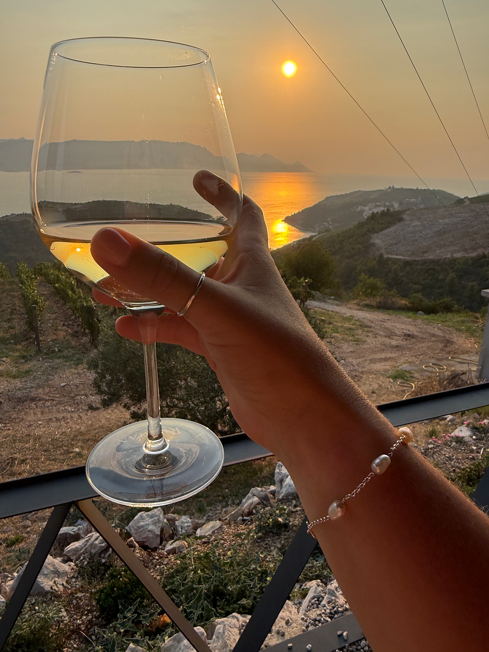 Thumbnail: hand holding wine glass with silver pearl bracelet on wrist