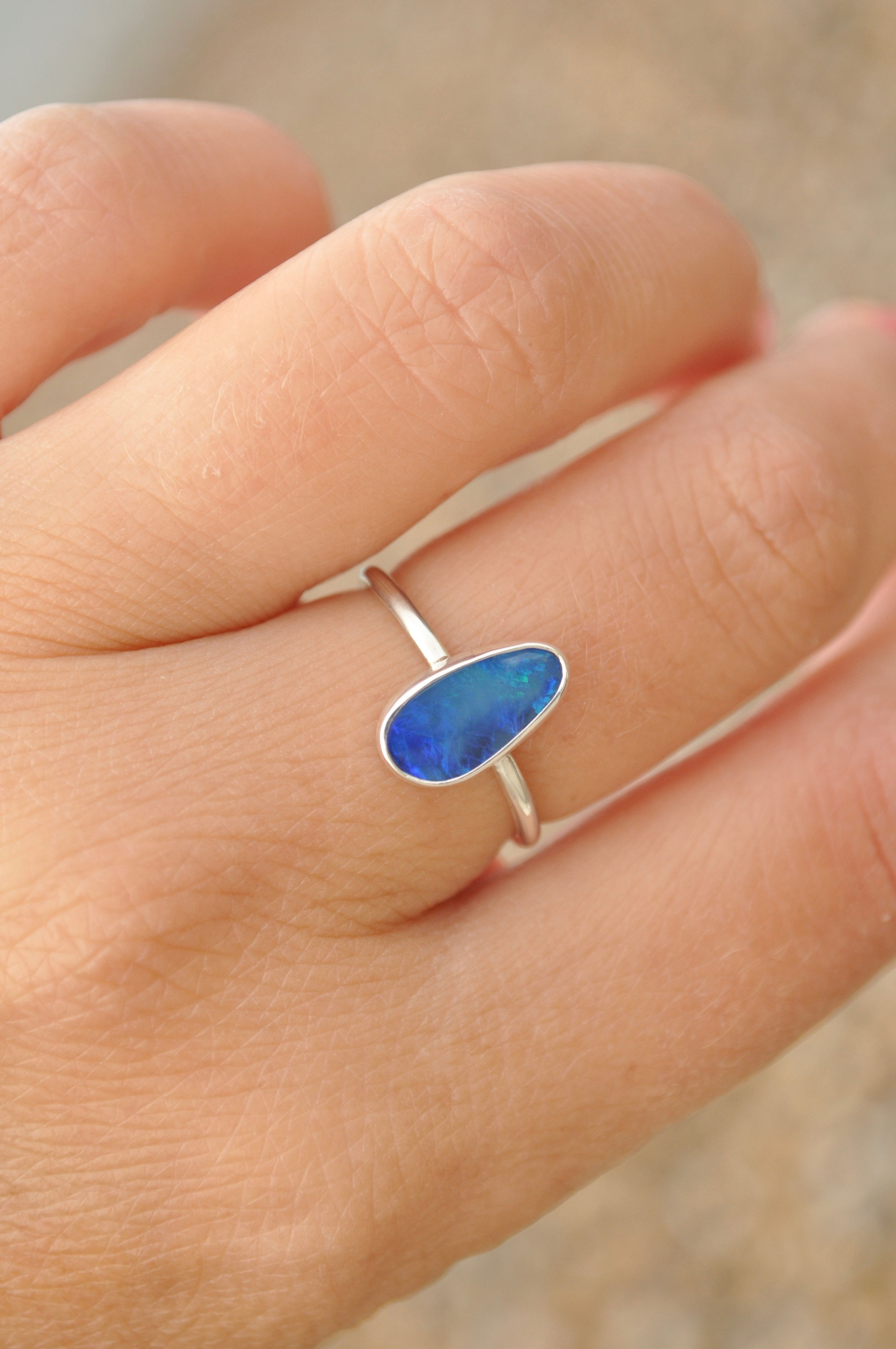 Large handmade simple silver blue opal ring on hand
