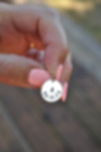 hand holding personalised silver hand stamped initial pendant with date of birth