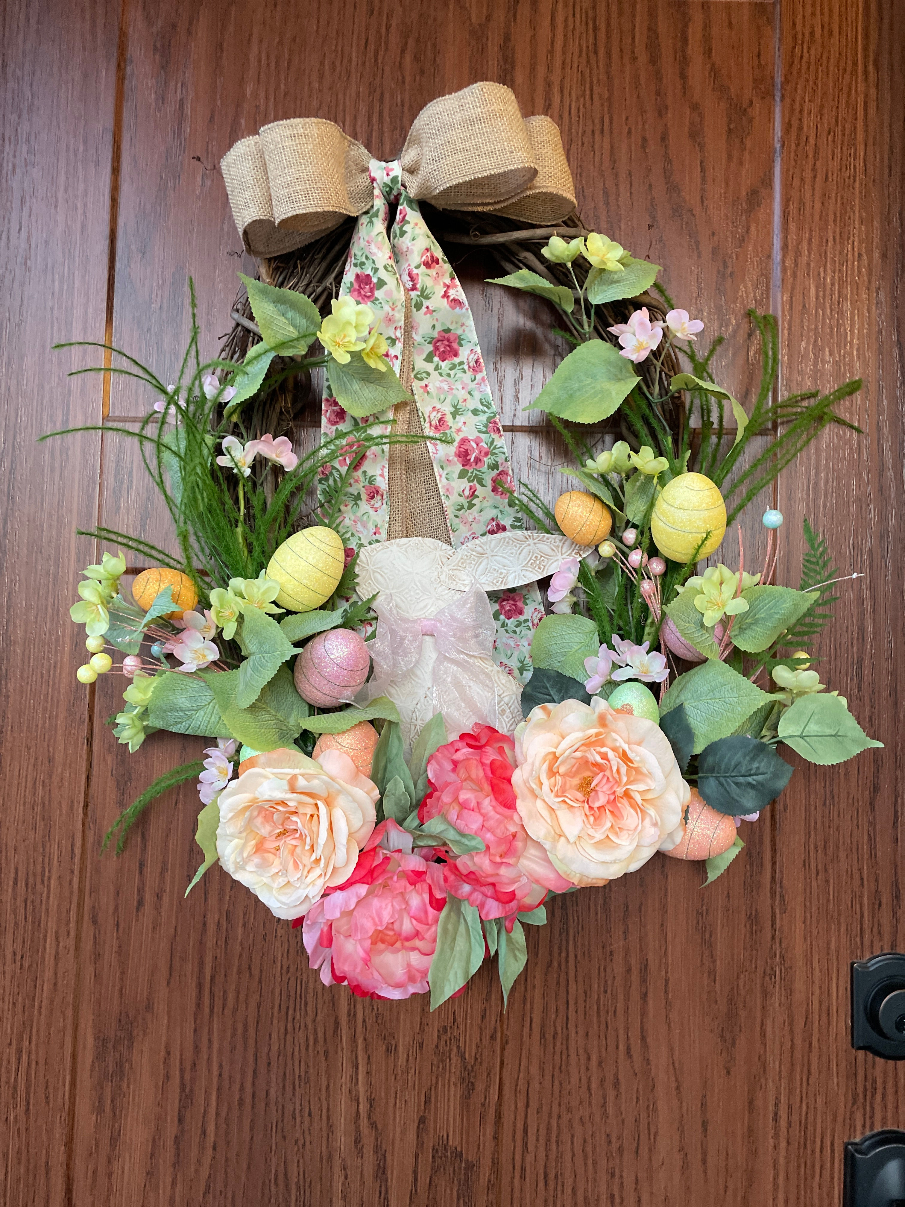 Front view of "Easter Beauty" handcrafted wreaths flowers, easter eggs, and a sweet easter bunny