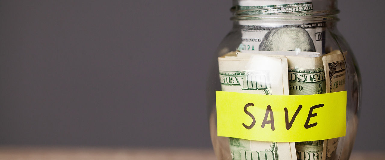 dollar-bills-in-glass-jar-on-wooden-table-2023-11-27-04-54-14-utc.jpg