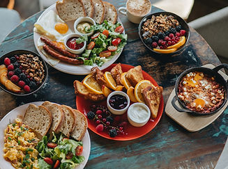 Delicious looking healthy dinner on multiple plates spread across a table. 