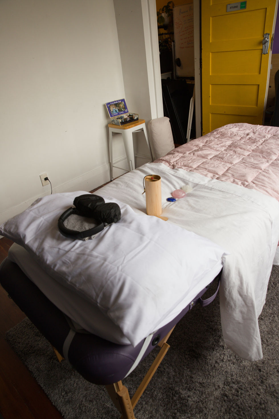 Temporary Reiki treatment space inside an artist studio with a yellow door at MoveSpace