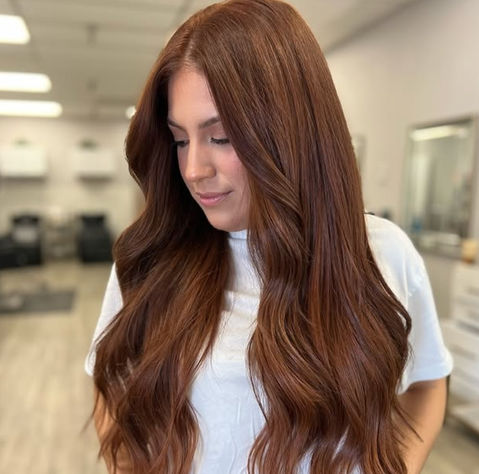 Woman with long, wavy auburn hair
