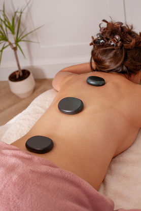 Wellness professional with a client during a holistic treatment