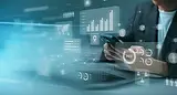 Business professional using a laptop with data analytics icons overlay