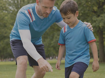 Coach teaching player. Aspire soccer development