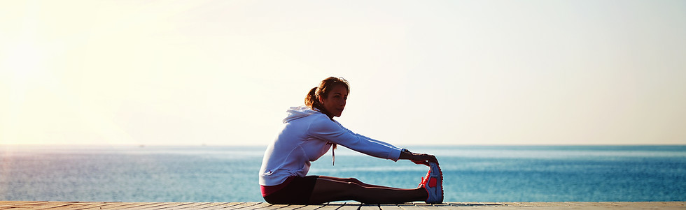 Woman Stretching by Ocean