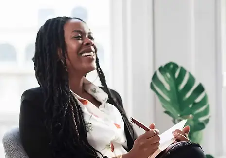 a professional black woman laughing