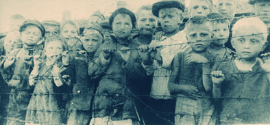 holocaust photo children behind barbed wire