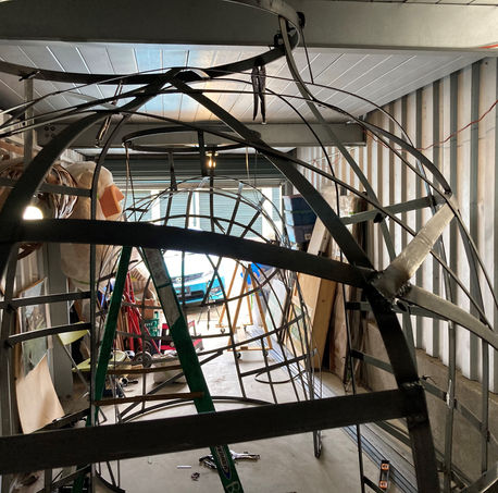 The arch's metal interior sitting in two main pieces inside a truck, waiting for assembly.