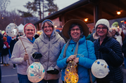 Group poses with HAC kit lanterns in front of the Pavilion.
