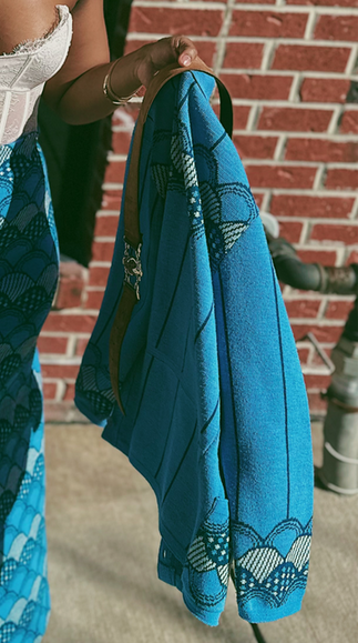 Close-up showing the detailed scalloped pattern of Mrs. VP's vintage blue sweater top