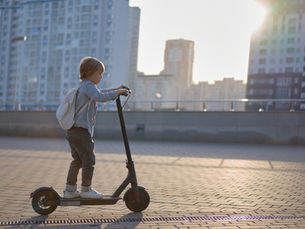 Boy Riding Electric Scooter Outdoors