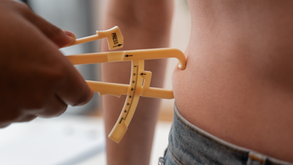 A torso being pinched by fat calipers