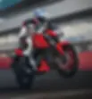 Motorcyclist in white and red gear jumps on a red TVS bike on a track. Background is blurred, conveying speed and energy.