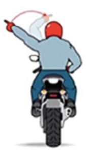 Motorcyclist with red helmet signals left turn with raised arm. View from behind, wearing blue jacket and jeans, on a black motorcycle.