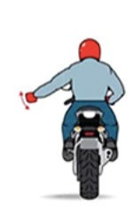 Motorcyclist in red helmet signals left turn with outstretched arm, wearing blue jeans and jacket, against a plain white background.