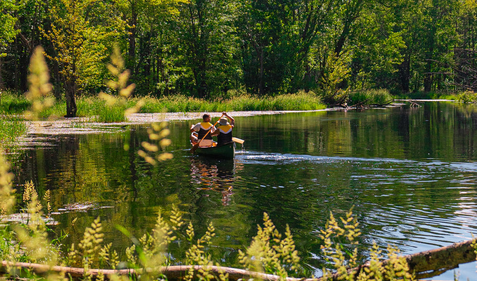 A couple canoeing on the beautiful Beaver Valley river which flows the property at Boho Beaver.