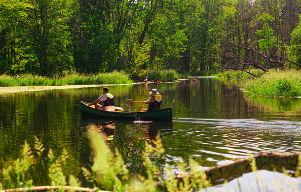 A couple in a canoe enjoying a relaxing paddle down the Beaver Valley river that runs through the Boho Beaver property.