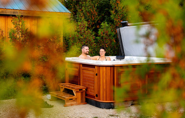 A couple relaxing in the salt water hot tub at Boho Beaver.