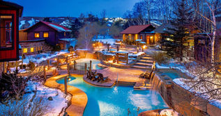 A gorgeous evening view of the Scandinave Spa lit up with Blue Mountain ski resort in the background.