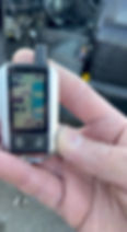 Hand holding a car remote with digital display in Saskatoon.