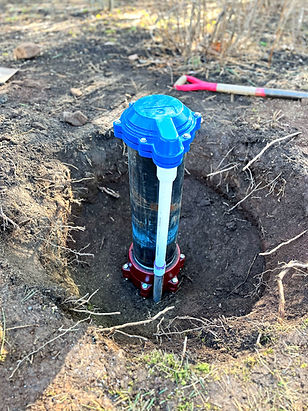 Well casing positioned 12 inches above ground level