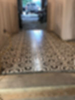 Intricate patterned flooring in a modern elevator area.