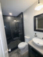 Modern bathroom home remodel with walk-in glass shower.
