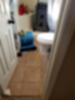 Professional water damage drying equipment in a bathroom.