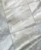 Grey marble tile flooring for a modern master bathroom.