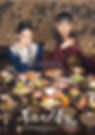 A dressed-up pair sits surrounded by colorful traditional dishes, holding chopsticks and spoons. Ornate background with floral patterns.