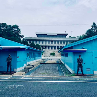 North Korean soldiers standing guard at the Joint Service Area of the DMZ. 