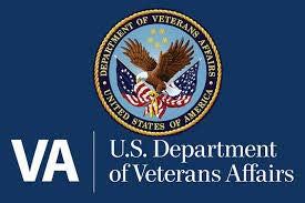 U.S. Department of Veterans Affairs logo on blue background with an eagle, flags, and stars. Text: "VA U.S. Department of Veterans Affairs."