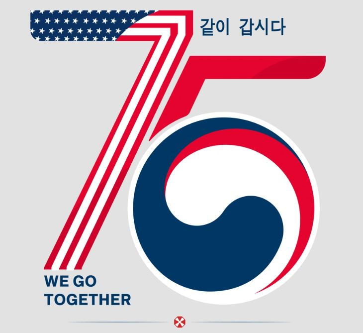 Stylized "75" with US and South Korean flag colors. Korean text and "WE GO TOGETHER." Patriotic theme, gray background.