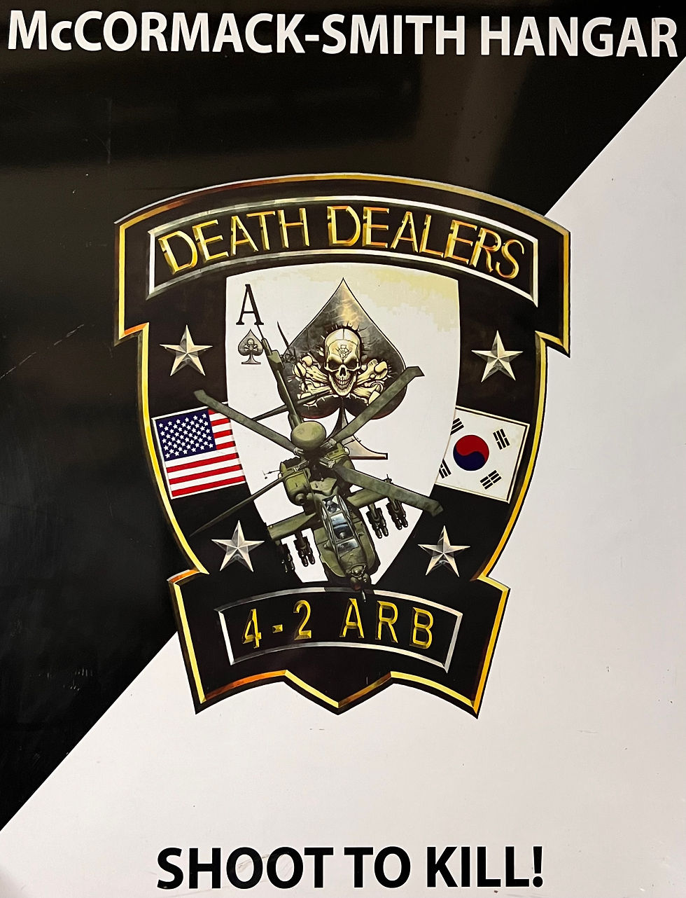 Logo with a skull and helicopter, flags of the USA and Korea. Text: McCORMACK-SMITH HANGAR, DEATH DEALERS, 4-2 ARB, SHOOT TO KILL!