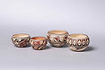 Four Hopi Bowls, Delaine Tootsie Chee (b. 1962) of the First Mesa Village of Sichomovi on the Hopi Reservation and is a member of the Roadrunner Clan. She is the winner of numerous awards for her pottery. These pots are hand-coiled of local clay, stone-polished, and outdoor-fired to a warm ivory tone, each bowl decorated in iron-red and black mineral/vegetal paints with traditional motifs, each base inscribed “D. TooTsie. Asa. Hopi”
1) 2.25"H, 3.75"D
2) 2.25"H, 3.25"D
3) 1.75"H, 2.75"D
4) 1.75"H, 2.75"D
Provenance: Hubbell Trading Post, Ganado AZ