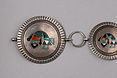 Sterling silver concho belt with mother of pearl, turquoise, coral and jet inlay rainbow man; Attributed to Frank Vacit; Ca. 40-50s; twelve conchos measuring approximately 1 1/2"D, buckle measures 1 7/8"D, with links that measure 33"
145 grams